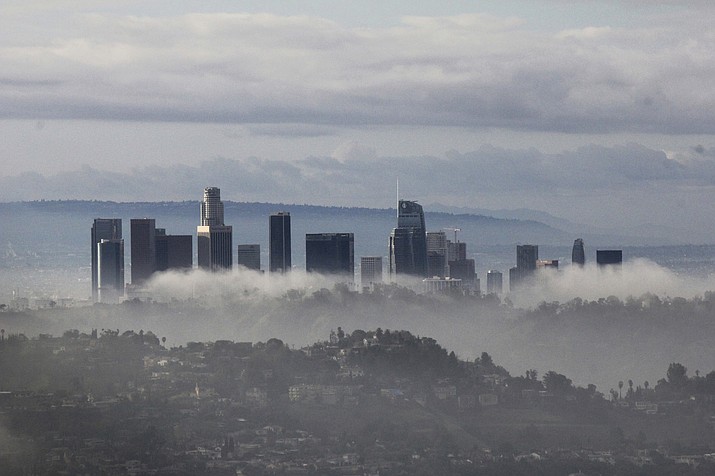 High-rises of downtown Los Angeles rise above clouds and mist on Sunday, Jan. 6, 2019, after an overnight storm that brought rain and mountain snow to Southern California. Rains unleashed debris flows from wildfire-scarred areas of the Santa Monica Mountains that inundated parts of Pacific Coast Highway. (John Antczak/AP)