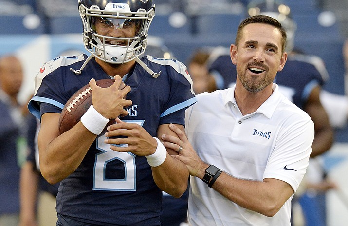 In this Aug. 30, 2018, file photo, Tennessee Titans quarterback Marcus Mariota (8) talks with offensive coordinator Matt LaFleur before a preseason NFL football game against the Minnesota Vikings in Nashville, Tenn. A person familiar with the decision says LaFleur has accepted Green Bay’s offer to become the next head coach of the Packers. (Mark Zaleski/AP, file)