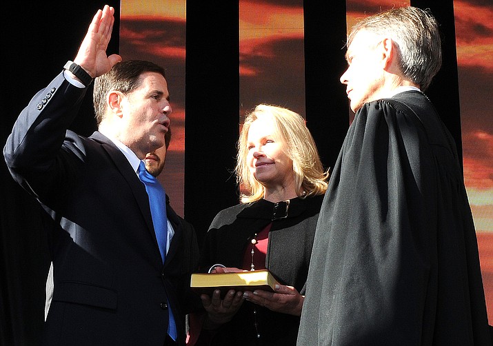 With wife Angela at his side, Gov. Doug Ducey is sworn in Monday for a second term by Arizona Chief Justice Scott Bales (Capitol Media Services photo by Howard Fischer)