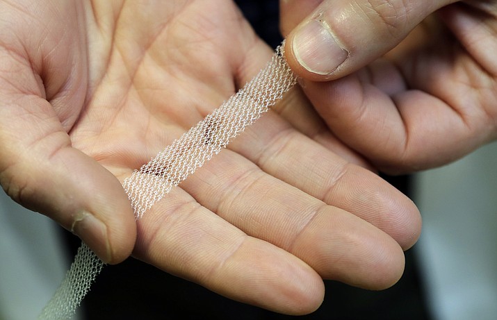 Dr. Jeffrey Clemons, a pelvic reconstructive surgeon, holds a sample of transvaginal mesh used to treat pelvic floor disorders and incontinence in women as he poses for a photo Dec. 20, 2018, in Tacoma, Wash. (Ted S. Warren/AP)