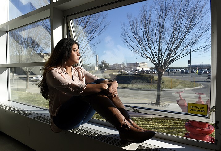 In this Feb. 2, 2016, image, Naila Amin, 26, looks out from a classroom window at Nassau Community College in Garden City, N.Y. According to data provided to The Associated Press, the U.S. approved thousands of requests by men to bring child and teenage brides from another country. “My passport ruined my life,” said Naila Amin, a dual citizen from Pakistan who grew up in New York City. She was forcibly married at 13 in Pakistan and applied for papers for her 26-year-old husband to come to the country. “People die to come to America. I was a passport to him. They all wanted him here, and that was the way to do it.” (Kathy Kmonicek/AP, file)