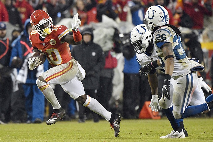 Kansas City Chiefs wide receiver Tyreek Hill (10) gestures as he runs past Indianapolis Colts safety Clayton Geathers (26) and linebacker Anthony Walker during the second half of an NFL divisional football playoff game in Kansas City, Mo., Saturday, Jan. 12, 2019. (Ed Zurga/AP)