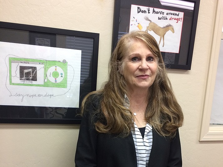 MatForce Executive Director Merilee Fowler stands in the Prescott Valley conference room of Yavapai County’s substance abuse prevention coalition decorated with student art selected as part of the agency’s poster art contests. The posters reflect student messages: “Don’t Horse Around With Drugs,” “Now Playing – Crack is Whack: Say Nope to Dope.” (Nanci Hutson/Courier)