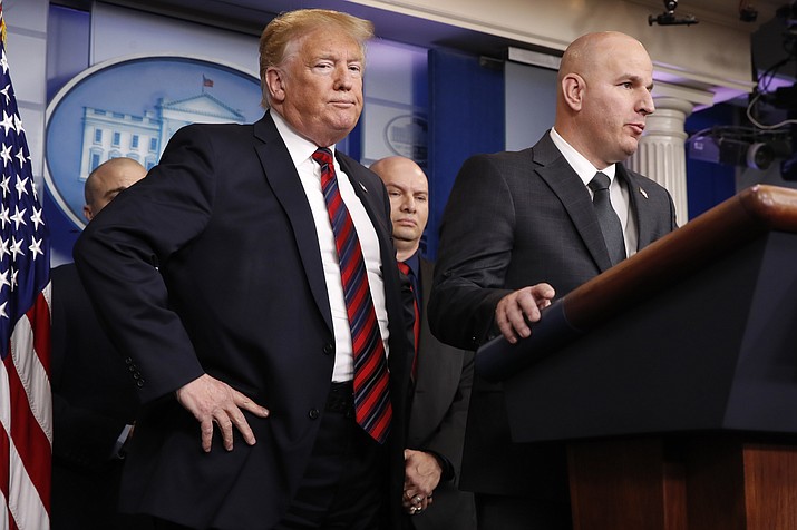 In this Jan. 3, 2019, file photo, President Donald Trump, left, listens as Brandon Judd, president of the National Border Patrol Council, talks about border security after making a surprise visit to the press briefing room of the White House in Washington. Trump and Judd share an ominous view of the southern border and a certainty that a wall along the boundary is urgently needed to stop what they’ve described as a humanitarian crisis. Judd, a 21-year veteran of the U.S. Border Patrol, has helped to validate Trump’s fiery immigration rhetoric and affirm the president’s conviction the border with Mexico is a frequently lawless place. (AP Photo/Jacquelyn Martin, File)