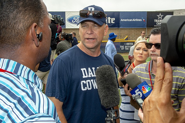 In this July 28, 2018, file photo, Dallas Cowboys offensive coordinator Scott Linehan talks with the media after morning practice at NFL football training camp, in Oxnard, Calif. Scott Linehan is out as offensive coordinator of the Dallas Cowboys only days after coach Jason Garrett sent mixed messages about the oft-criticized assistant's future. Garrett said in a statement released by the team Friday, Jan. 18, 2019, that he and Linehan had some open discussions this week and mutually agreed that a change was needed after five seasons. (Gus Ruelas/AP, file)