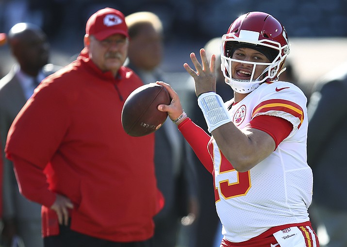 In this Dec. 2, 2018, file photo, Kansas City Chiefs coach Andy Reid, left, watches quarterback Patrick Mahomes (15) warm up for the team's NFL football game against the Oakland Raiders in Oakland, Calif. The Chiefs (12-4) get this week to rest and relax, the byproduct of earning that first-round bye. They will learn this weekend whether they will face the Colts, Ravens or Chargers in the divisional round on Jan. 12, the first of what they hope will be two games at Arrowhead Stadium before the Super Bowl. (Ben Margot/AP, file)