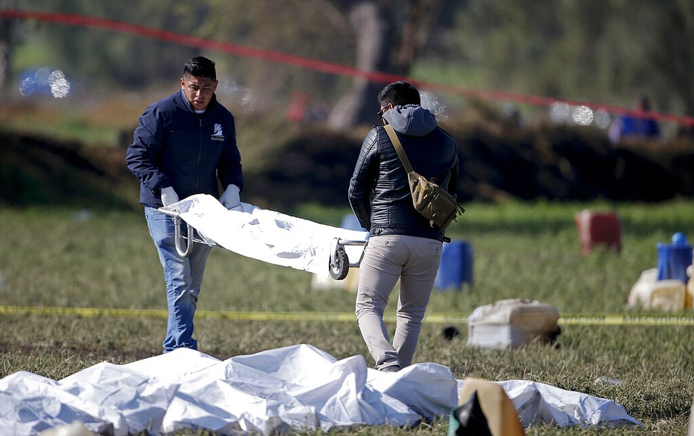 Forensic experts working in the area an oil pipeline explosion in Tlahuelilpan, Hidalgo state, Mexico, Saturday, Jan. 19, 2019. A massive fireball that engulfed people scooping up fuel spilling from a pipeline ruptured by thieves in central Mexico killed dozens of people and badly burned many more. (AP Photo/Claudio Cruz)