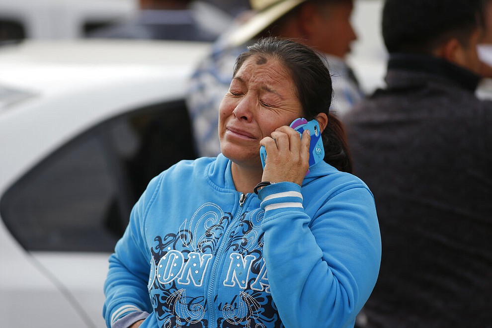 A woman cries outside a funeral service in Tula, Hidalgo state, Mexico, Saturday, Jan. 19, 2019. A massive fireball that engulfed people scooping up fuel spilling from a pipeline ruptured by thieves in central Mexico killed multiple people and badly burned others. (AP Photo/Claudio Cruz)