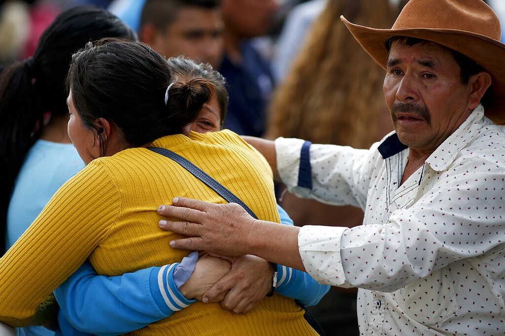 Family embrace outside a funeral service in Tula, Hidalgo state, Mexico, Saturday, Jan. 19, 2019. A massive fireball that engulfed people scooping up fuel spilling from a pipeline ruptured by thieves in central Mexico killed multiple people and badly burned others. (AP Photo/Claudio Cruz)