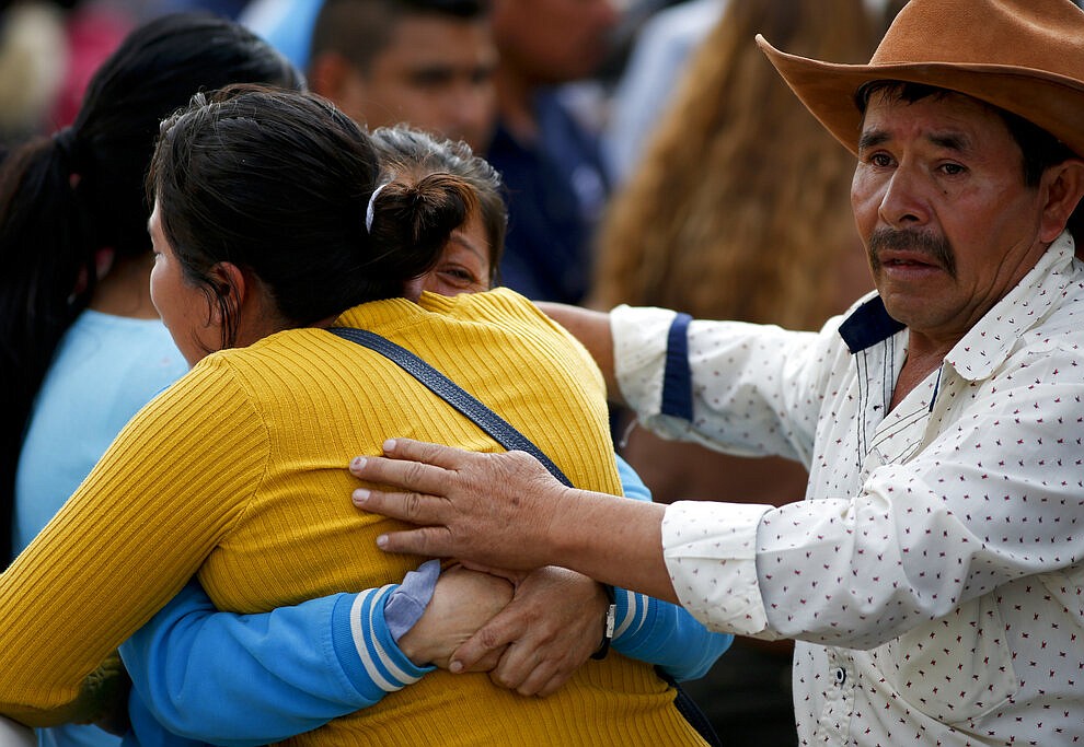 Family embrace outside a funeral service in Tula, Hidalgo state, Mexico, Saturday, Jan. 19, 2019. A massive fireball that engulfed people scooping up fuel spilling from a pipeline ruptured by thieves in central Mexico killed multiple people and badly burned others. (AP Photo/Claudio Cruz)