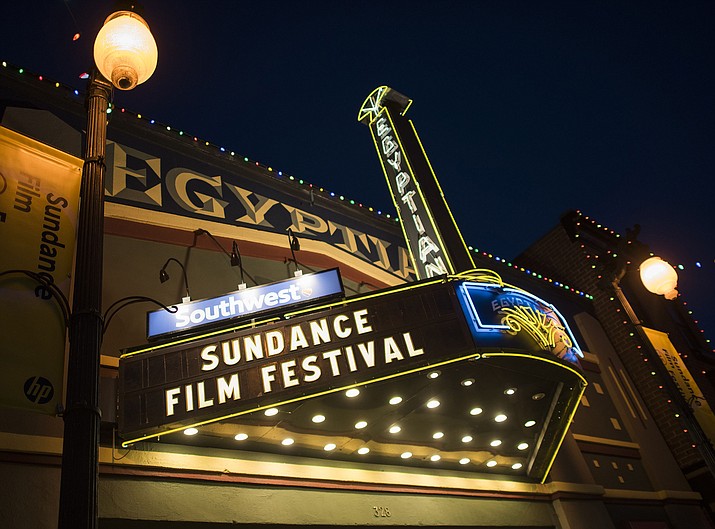 In this Thursday, Jan. 22, 2015, file photo, the Egyptian Theatre is lit up on Main Street during the first night of the Sundance Film Festival in Park City, Utah. The mountainside festival, which kicks off Thursday, Jan. 24, 2019, in Park City, Utah, has become known for launching nonfiction films to box office successes and awards, and this year is shaping up to be no different. (Arthur Mola/Invision/AP, File)