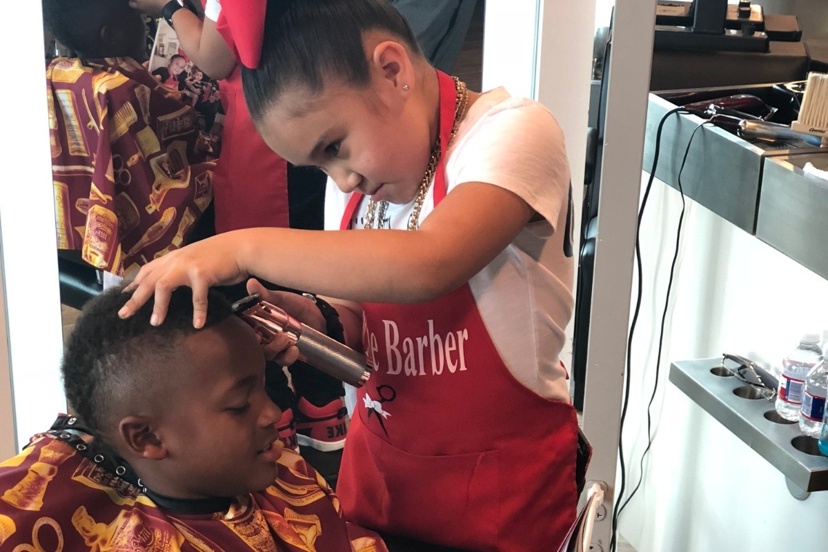 Watch 7 year old barber shows of hair cutting skills 