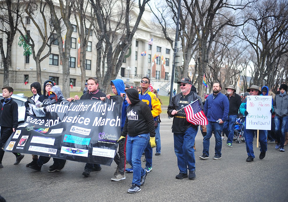 Several hundred people, young, old, male, female and of different racial backgrounds braved the cold, freezing rain and wind to march in the annual Martin Luther King Jr. Peace and Justice march through the downtown area Monday Jan. 21, 2019 in Prescott. .The march started at Prescott College down Gurley Street and around the Yavapai County Courthouse Plaza and returned to Prescott College. (Les Stukenberg/Courier).