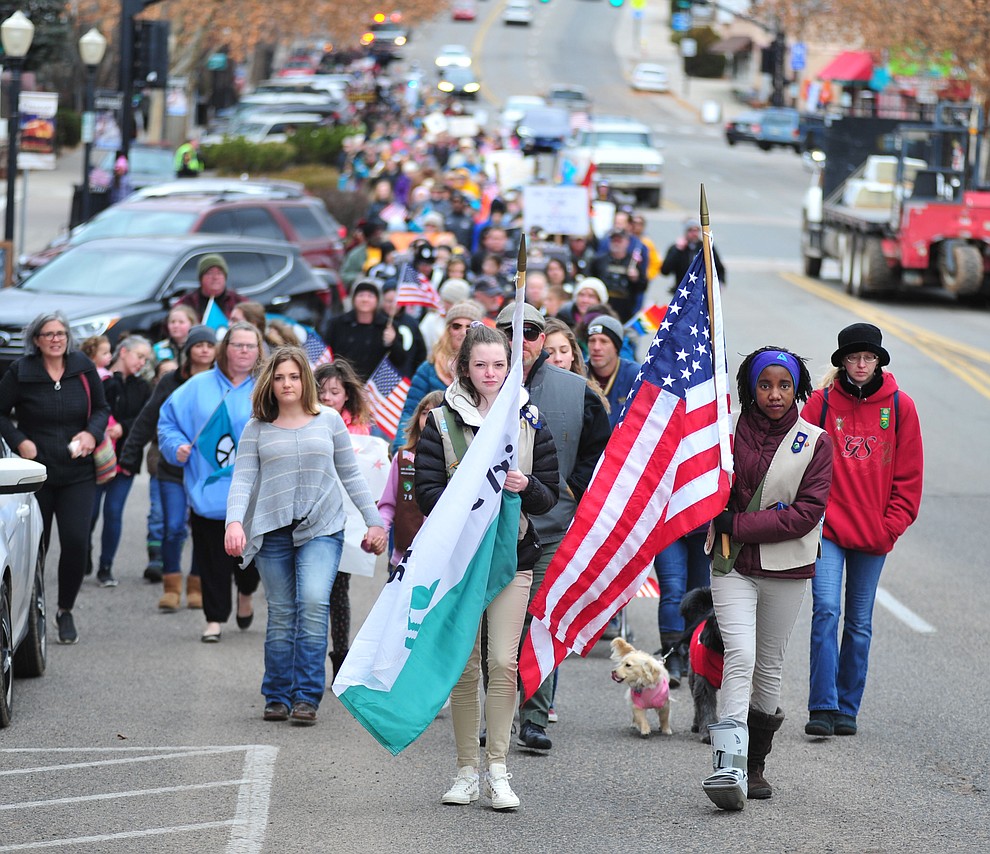 Several hundred people, young, old, male, female and of different racial backgrounds braved the cold, freezing rain and wind to march in the annual Martin Luther King Jr. Peace and Justice march through the downtown area Monday Jan. 21, 2019 in Prescott. .The march started at Prescott College down Gurley Street and around the Yavapai County Courthouse Plaza and returned to Prescott College. (Les Stukenberg/Courier).