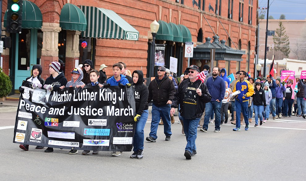Several hundred people, young, old, male, female and of different racial backgrounds braved the cold, freezing rain and wind to march in the annual Martin Luther King Jr. Peace and Justice march through the downtown area Monday Jan. 21, 2019 in Prescott. .The march started at Prescott College down Gurley Street and around the Yavapai County Courthouse Plaza and returned to Prescott College. (Les Stukenberg/Courier).