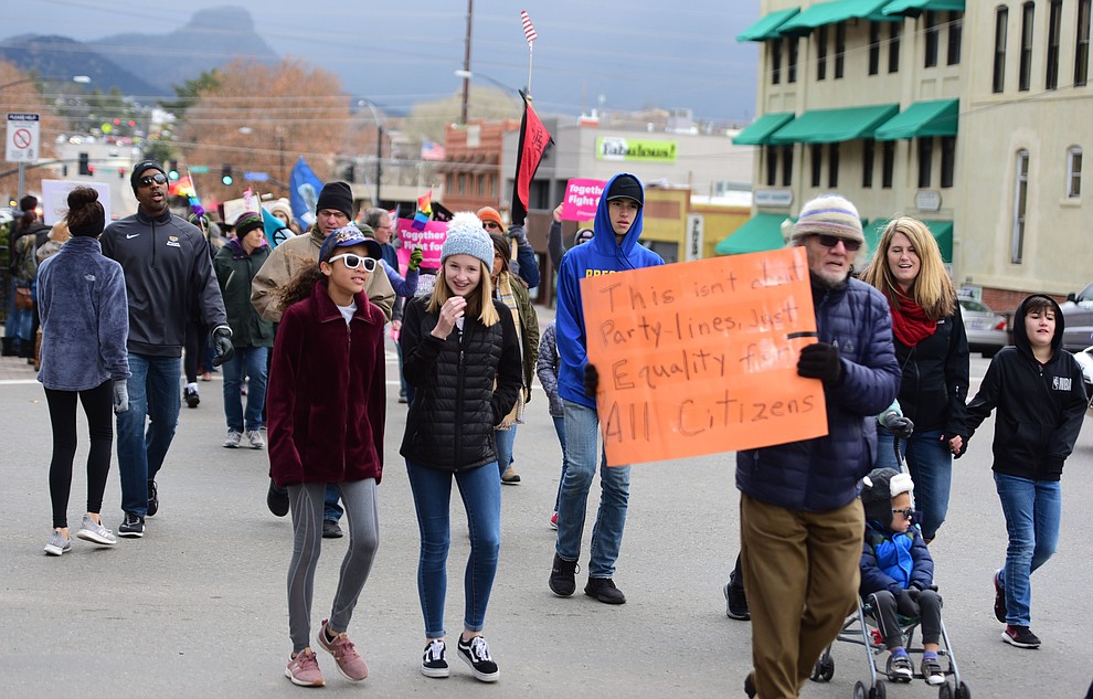 Several hundred people, young, old, male, female and of different racial backgrounds braved the cold, freezing rain and wind to march in the annual Martin Luther King Jr. Peace and Justice march through the downtown area Monday Jan. 21, 2019 in Prescott. .The march started at Prescott College down Gurley Street and around the Yavapai County Courthouse Plaza and returned to Prescott College. (Les Stukenberg/Courier).