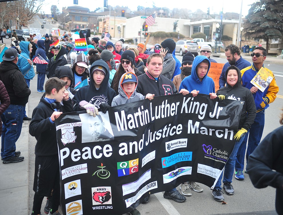 Several hundred people, young, old, male, female and of different racial backgrounds braved the cold, freezing rain and wind to march in the annual Martin Luther King Jr. Peace and Justice march through the downtown area Monday Jan. 21, 2019 in Prescott. .The march started at Prescott College down Gurley Street and around the Yavapai County Courthouse Plaza and returned to Prescott College. (Les Stukenberg/Courier).