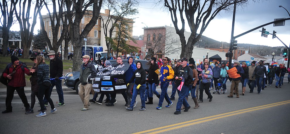 Several hundred people, young, old, male, female and of different racial backgrounds braved the cold, freezing rain and wind to march in the annual Martin Luther King Jr. Peace and Justice march through the downtown area Monday Jan. 21, 2019 in Prescott. .The march started at Prescott College down Gurley Street and around the Yavapai County Courthouse Plaza and returned to Prescott College. (Les Stukenberg/Courier).