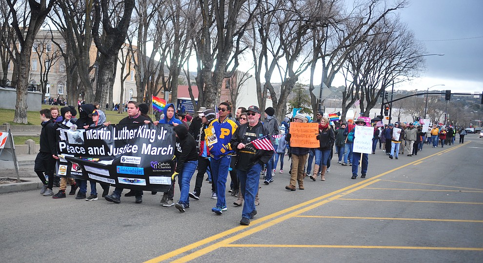 Several hundred people, young, old, male, female and of different racial backgrounds braved the cold, freezing rain and wind to march in the annual Martin Luther King Jr. Peace and Justice march through the downtown area Monday Jan. 21, 2019 in Prescott. .The march started at Prescott College down Gurley Street and around the Yavapai County Courthouse Plaza and returned to Prescott College. (Les Stukenberg/Courier).