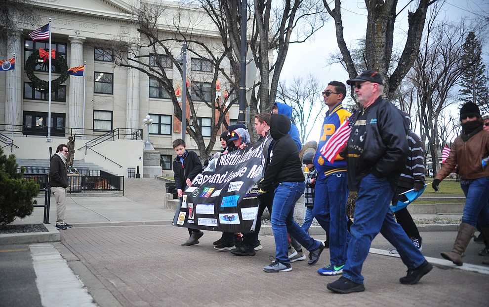 Several hundred people, young, old, male, female and of different racial backgrounds braved the cold, freezing rain and wind to march in the annual Martin Luther King Jr. Peace and Justice march through the downtown area Monday Jan. 21, 2019 in Prescott. .The march started at Prescott College down Gurley Street and around the Yavapai County Courthouse Plaza and returned to Prescott College. (Les Stukenberg/Courier).