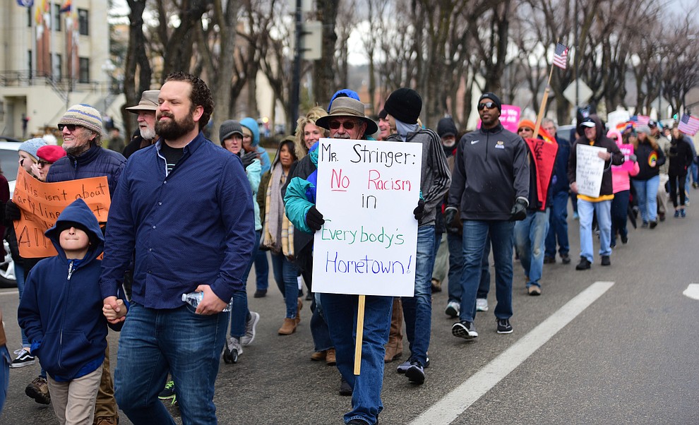Several hundred people, young, old, male, female and of different racial backgrounds braved the cold, freezing rain and wind to march in the annual Martin Luther King Jr. Peace and Justice march through the downtown area Monday Jan. 21, 2019 in Prescott. .The march started at Prescott College down Gurley Street and around the Yavapai County Courthouse Plaza and returned to Prescott College. (Les Stukenberg/Courier).