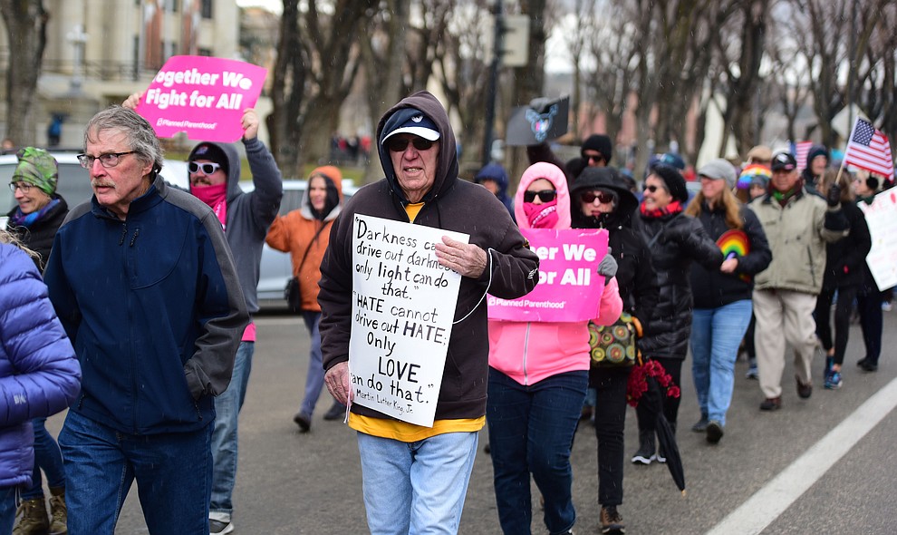 Several hundred people, young, old, male, female and of different racial backgrounds braved the cold, freezing rain and wind to march in the annual Martin Luther King Jr. Peace and Justice march through the downtown area Monday Jan. 21, 2019 in Prescott. .The march started at Prescott College down Gurley Street and around the Yavapai County Courthouse Plaza and returned to Prescott College. (Les Stukenberg/Courier).