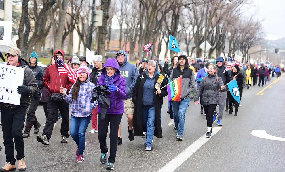Several hundred people, young, old, male, female and of different racial backgrounds braved the cold, freezing rain and wind to march in the annual Martin Luther King Jr. Peace and Justice march through the downtown area Monday Jan. 21, 2019 in Prescott. .The march started at Prescott College down Gurley Street and around the Yavapai County Courthouse Plaza and returned to Prescott College. (Les Stukenberg/Courier).