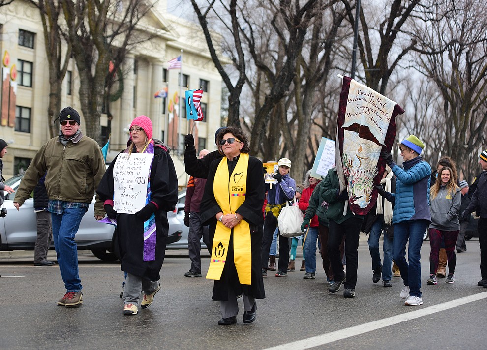 Several hundred people, young, old, male, female and of different racial backgrounds braved the cold, freezing rain and wind to march in the annual Martin Luther King Jr. Peace and Justice march through the downtown area Monday Jan. 21, 2019 in Prescott. .The march started at Prescott College down Gurley Street and around the Yavapai County Courthouse Plaza and returned to Prescott College. (Les Stukenberg/Courier).