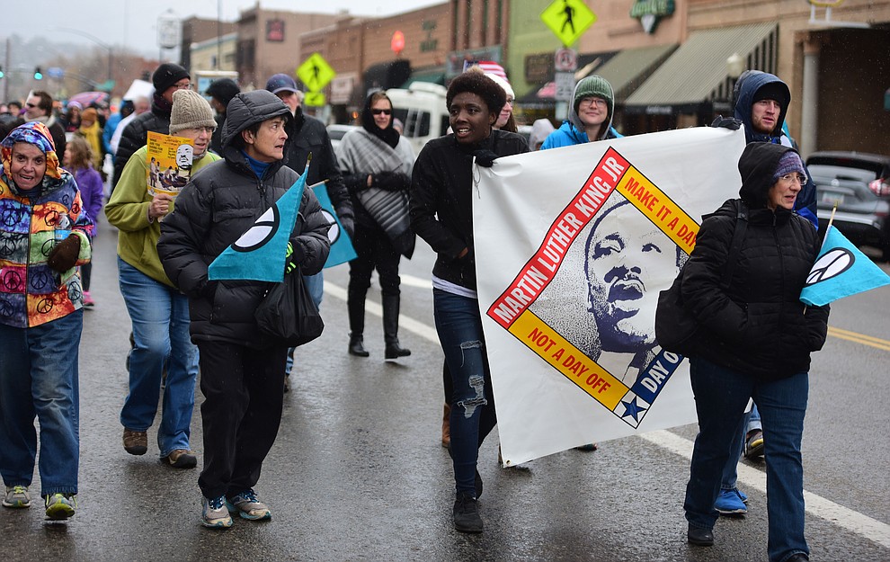 Several hundred people, young, old, male, female and of different racial backgrounds braved the cold, freezing rain and wind to march in the annual Martin Luther King Jr. Peace and Justice march through the downtown area Monday Jan. 21, 2019 in Prescott. .The march started at Prescott College down Gurley Street and around the Yavapai County Courthouse Plaza and returned to Prescott College. (Les Stukenberg/Courier).