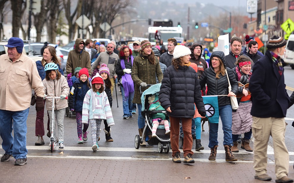 Several hundred people, young, old, male, female and of different racial backgrounds braved the cold, freezing rain and wind to march in the annual Martin Luther King Jr. Peace and Justice march through the downtown area Monday Jan. 21, 2019 in Prescott. .The march started at Prescott College down Gurley Street and around the Yavapai County Courthouse Plaza and returned to Prescott College. (Les Stukenberg/Courier).