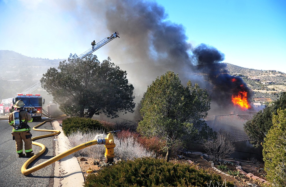 Prescott and Central Arizona and Chino Valley firefighters responded to a three-alarm structure fire in the 3000 block of Rainbow Ridge in the Ranch subdivision of Prescott Tuesday, Jan. 22, 2019. (Les Stukenberg/Courier).