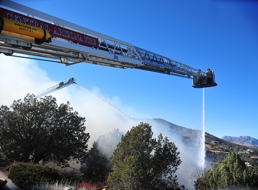 Prescott and Central Arizona and Chino Valley firefighters responded to a three-alarm structure fire in the 3000 block of Rainbow Ridge in the Ranch subdivision of Prescott Tuesday, Jan. 22, 2019. (Les Stukenberg/Courier).