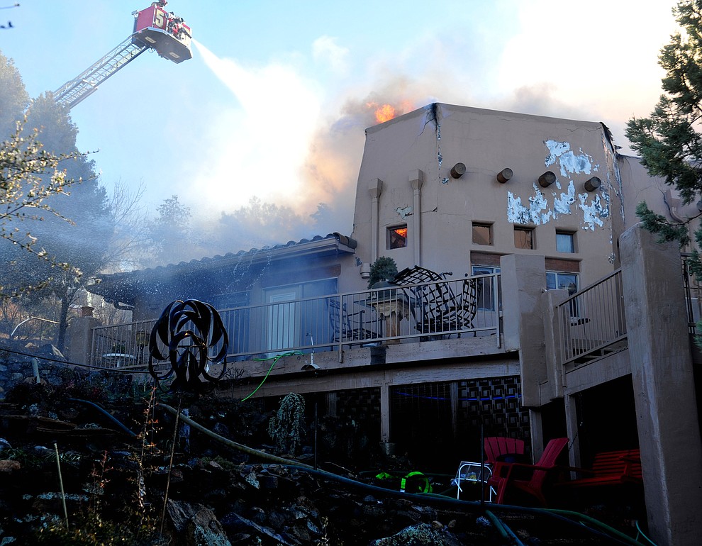 Prescott and Central Arizona and Chino Valley firefighters responded to a three-alarm structure fire in the 3000 block of Rainbow Ridge in the Ranch subdivision of Prescott Tuesday, Jan. 22, 2019. (Les Stukenberg/Courier).