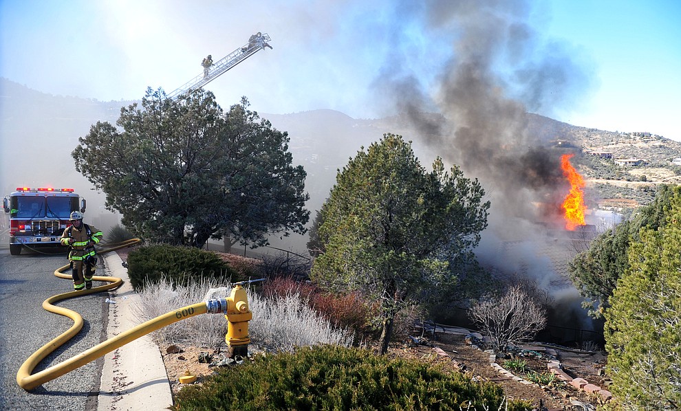 Prescott and Central Arizona and Chino Valley firefighters responded to a three-alarm structure fire in the 3000 block of Rainbow Ridge in the Ranch subdivision of Prescott Tuesday, Jan. 22, 2019. (Les Stukenberg/Courier).