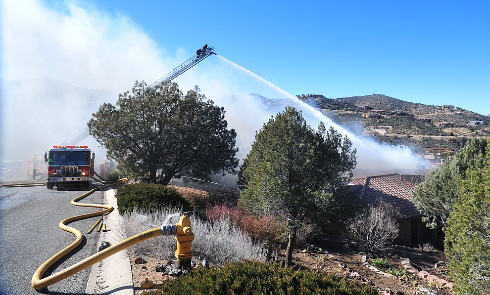 Prescott and Central Arizona and Chino Valley firefighters responded to a three-alarm structure fire in the 3000 block of Rainbow Ridge in the Ranch subdivision of Prescott Tuesday, Jan. 22, 2019. (Les Stukenberg/Courier).