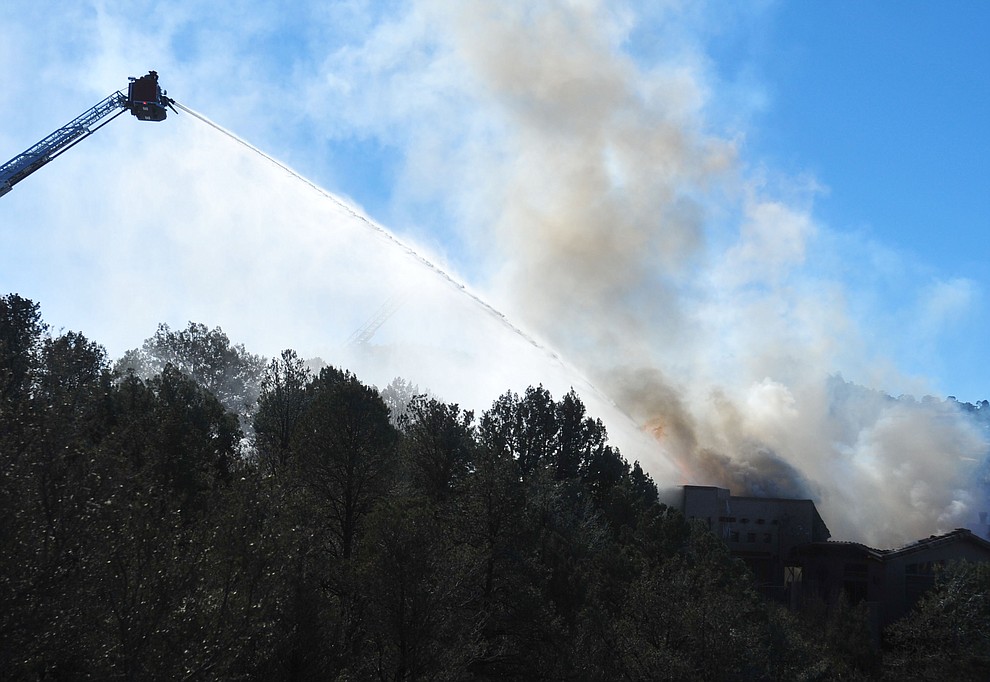 Prescott and Central Arizona and Chino Valley firefighters responded to a three-alarm structure fire in the 3000 block of Rainbow Ridge in the Ranch subdivision of Prescott Tuesday, Jan. 22, 2019. (Les Stukenberg/Courier).