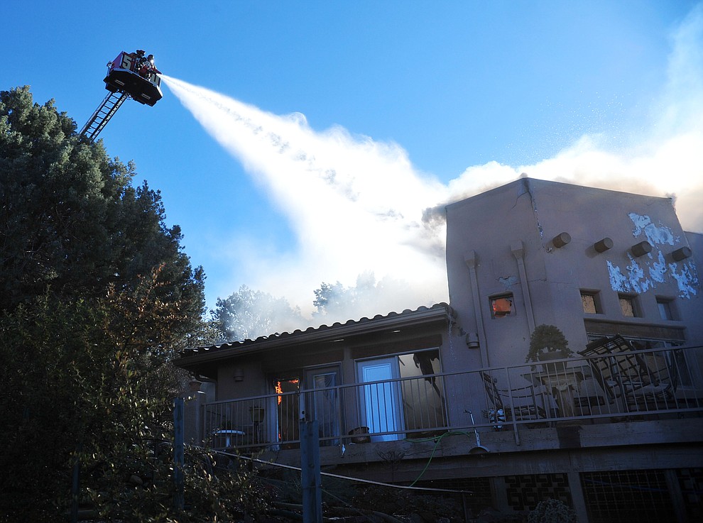 Prescott and Central Arizona and Chino Valley firefighters responded to a three-alarm structure fire in the 3000 block of Rainbow Ridge in the Ranch subdivision of Prescott Tuesday, Jan. 22, 2019. (Les Stukenberg/Courier).