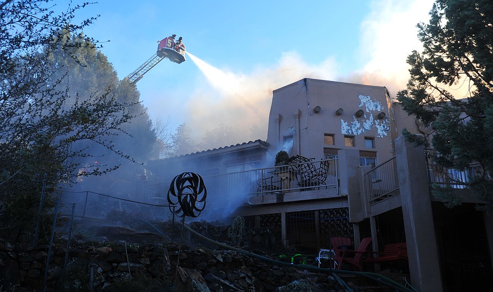 Prescott and Central Arizona and Chino Valley firefighters responded to a three-alarm structure fire in the 3000 block of Rainbow Ridge in the Ranch subdivision of Prescott Tuesday, Jan. 22, 2019. (Les Stukenberg/Courier).