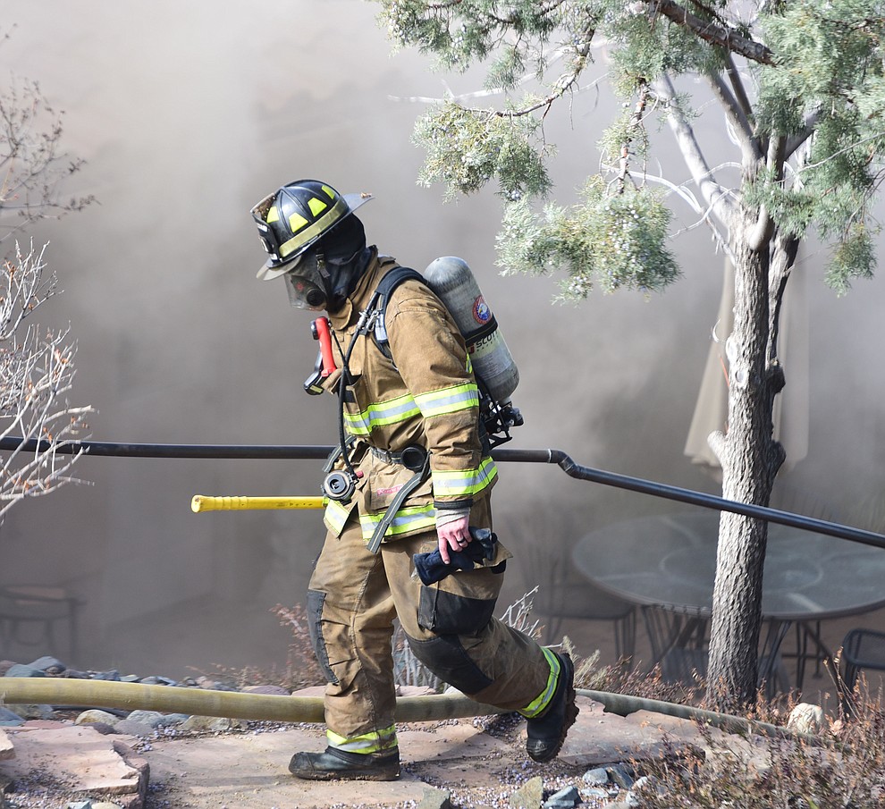 Prescott and Central Arizona and Chino Valley firefighters responded to a three-alarm structure fire in the 3000 block of Rainbow Ridge in the Ranch subdivision of Prescott Tuesday, Jan. 22, 2019. (Les Stukenberg/Courier).