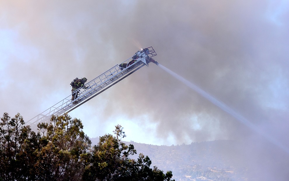 Prescott and Central Arizona and Chino Valley firefighters responded to a three-alarm structure fire in the 3000 block of Rainbow Ridge in the Ranch subdivision of Prescott Tuesday, Jan. 22, 2019. (Les Stukenberg/Courier).