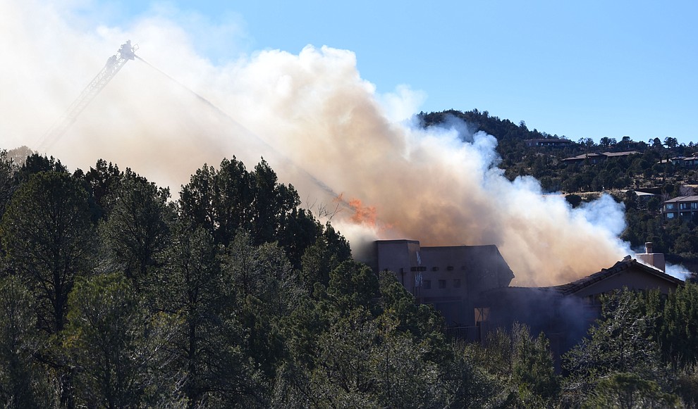 Prescott and Central Arizona and Chino Valley firefighters responded to a three-alarm structure fire in the 3000 block of Rainbow Ridge in the Ranch subdivision of Prescott Tuesday, Jan. 22, 2019. (Les Stukenberg/Courier).