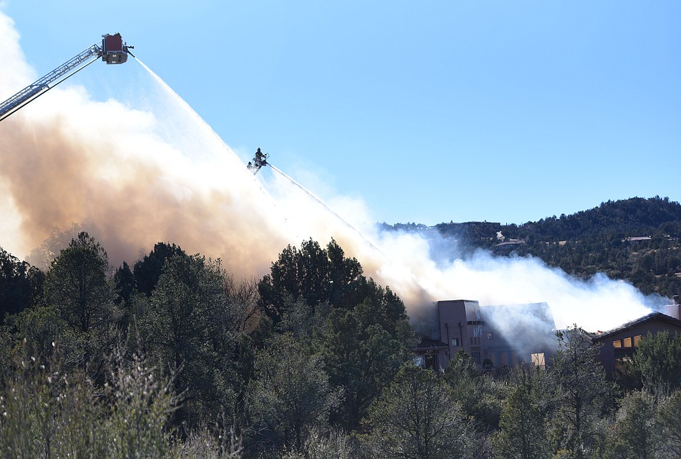 Prescott and Central Arizona and Chino Valley firefighters responded to a three-alarm structure fire in the 3000 block of Rainbow Ridge in the Ranch subdivision of Prescott Tuesday, Jan. 22, 2019. (Les Stukenberg/Courier).