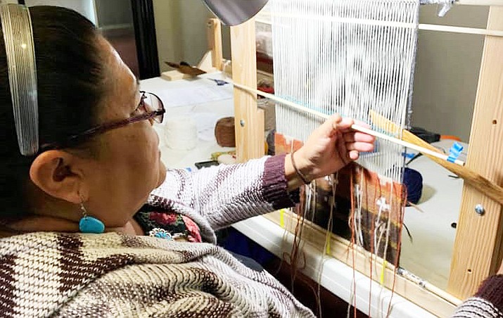Diné College NCAP student Tamerra Martin works on a weaving project at a recent workshop in Phoenix. (Photo/Diné College)