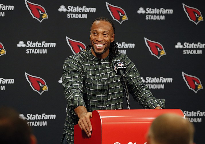 In this Dec. 23, 2018, file photo, Arizona Cardinals wide receiver Larry Fitzgerald speaks after an NFL football game against the Los Angeles Rams, in Glendale, Ariz. Star receiver Larry Fitzgerald is returning to the Arizona Cardinals for a 16th NFL season. The Cardinals announced Wednesday, Jan. 23, 2019, that they signed the 35-year-old Fitzgerald to a one-year contract. Team president Michael Bidwell says, “No player has meant more to this franchise or this community than Larry Fitzgerald.” (Rick Scuteri/AP, file)