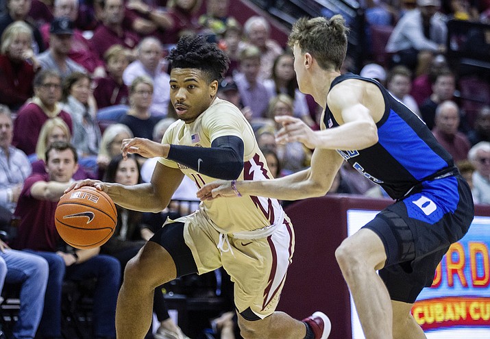 FILE- This Jan. 12, 2019, file photo shows Florida State guard David Nichols trying  to get past Duke guard Alex O'Connell in the second half of an NCAA college basketball game in Tallahassee, Fla. The 22-year-old Nichols, who was born in Chicago, became just the second graduate transfer at Florida State and has carved a niche in the lineup of the Seminoles, who were ranked No. 11 before falling out of the poll this week after three straight losses. (Mark Wallheiser/AP, file)