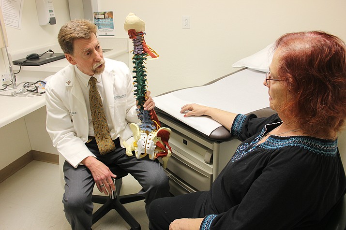 Dr. Steven Galper, a pain doctor in Prescott, speaks with his patient Rachel Turet about pain she experiences from her arthritis and fibromyalgia. (Max Efrein/Courier)
