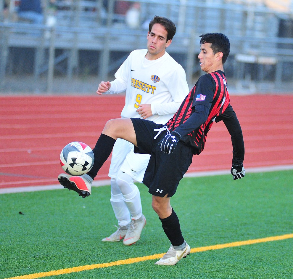 Bradshaw Mountain's Eddie Estrada Vasquez keeps the ball inplay in front of Prescott's Nathaniel Koehler as the Bears play the Prescott Badgers Tuesday, Jan. 29, 2019 in Prescott Valley. (Les Stukenberg/Courier).