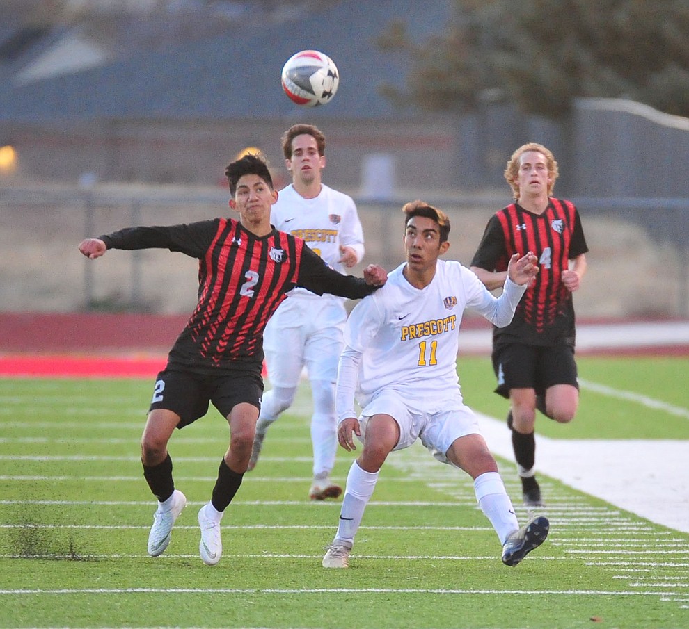 Bradshaw Mountain's AJ Villafana and Prescott's Claudio Orozco go for the ball as the Bears play the Prescott Badgers Tuesday, Jan. 29, 2019 in Prescott Valley. (Les Stukenberg/Courier).