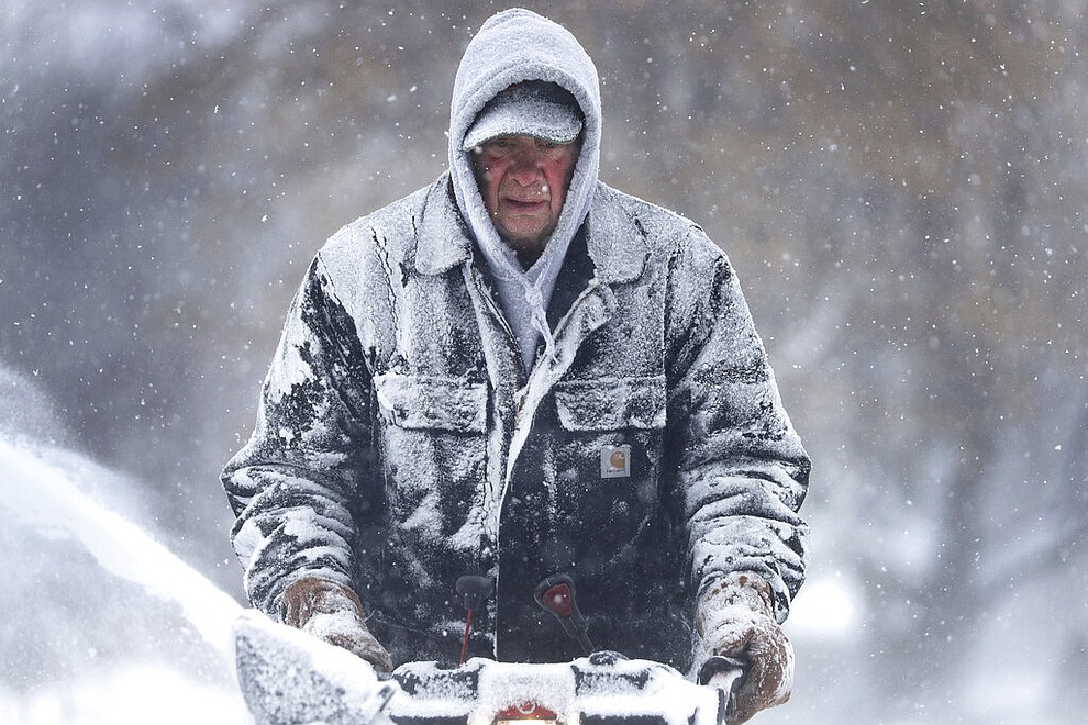 Gary Verstegen clears a sidewalk as a winter storm moves through Wisconsin on Monday, Jan. 28, 2019, in Little Chute, Wis. (William Glasheen/The Post-Crescent via AP)