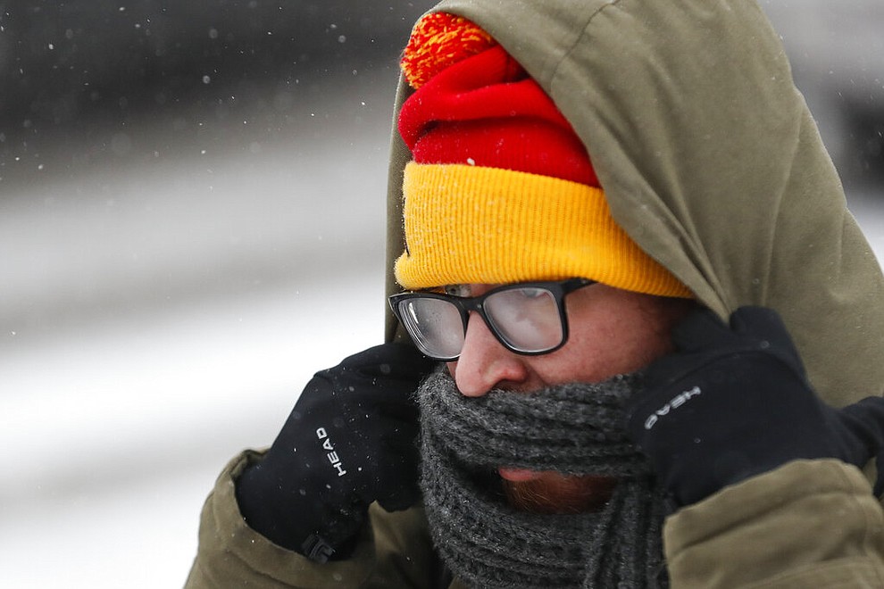 Commuters braves the wind and snow in frigid weather, Wednesday, Jan. 30, 2019, in Cincinnati. The extreme cold and record-breaking temperatures are crawling into a swath of states spanning from North Dakota to Missouri and into Ohio after a powerful snowstorm pounded the region earlier this week. (AP Photo/John Minchillo)
